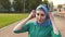 Portrait sports muslim girl in headphones at the stadium slow mo