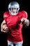 Portrait of sportsman pointing while holding American football