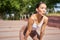 Portrait of sportswoman panting, taking break during jogging training, sweating while running outdoors