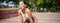 Portrait of sportswoman panting, taking break during jogging training, sweating while running outdoors