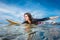 portrait of sportswoman in wetsuit on surfing board in ocean at Nusa dua Beach
