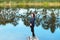 Portrait of sporty beautiful adult brunette woman the fall city park posing near blue lake with autumn trees reflections