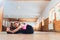 Portrait of sporty beautiful blond woman in sportswear working out indoors, doing variation of Upward Plank Posture, Eka