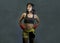 Portrait of sporty and fit fighter Asian Chinese woman using wrist wraps training mma fight sport or boxing workout looking danger