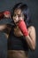 Portrait of sporty and fit fighter Asian Chinese woman using wrist wraps training mma fight sport or boxing workout looking danger