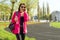 Portrait sporty mature woman at the stadium, in sports clothes for training, with bottle of water, talking on the phone