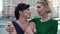 Portrait of stressed adult woman smiling as friend calming down worried lady. Two Caucasian women standing on urban city