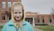 Portrait of a student on the background of a middle school building in the United States