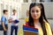 Portrait of student posing near college building