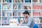 Portrait of student while reading book in school library