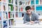 Portrait of student while reading book in school library