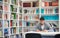 Portrait of student while reading book in school library