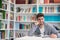 Portrait of student while reading book in school library