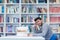 Portrait of student while reading book in school library