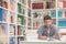 Portrait of student while reading book in school library