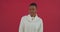 Portrait studio shooting african american woman ethnic girl model in white sweater isolated on red background shaking