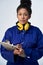 Portrait Of Studio Shot Of Female Engineer With Clipboard And Spanner Against White Background