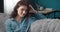 Portrait of stunning woman in denim shirt sitting on couch