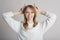 Portrait of a stylish and cheerful girl on a white background in the studio who shows funny grimaces.