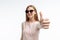 Portrait of a stylish emotional girl who shows hand gestures class, model posing in glasses on a white background for advertising