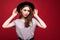 Portrait stylish girl wearing black hat isolated over red background
