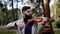 portrait of a stylish male musician with a violin performing a composition in the morning in the park.