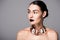 portrait of stylish nude girl posing wit black lips and trendy necklace