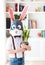 Portrait of stylish polygonal easter rabbit with a fresh spring potted flowers, polygonal mask