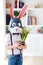 Portrait of stylish polygonal easter rabbit with a fresh spring potted flowers, polygonal mask