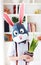 Portrait of stylish polygonal easter rabbit with a fresh spring potted flowers, polygonal mask