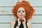 Portrait of stylish redhead young woman posing