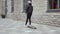 Portrait of stylish teenage young guy riding on the skateboard outdoor. Teenager with a skate board on the street. Sport