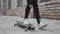Portrait of stylish teenage young guy riding on the skateboard outdoor. Teenager with a skate board on the street. Sport