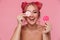 Portrait of stylish woman with colorful hairstyle holding makeup sponges