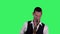 Portrait stylish young guy plays fast melody at saxophone on a green screen in the studio. Saxophonist performing a solo