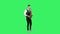 Portrait stylish young guy plays melody at saxophone on a green screen in the studio. Saxophonist performing a solo