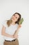 Portrait of succesful smiling woman in casual wear with green book on light background