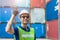Portrait of success foreman shipping Latin staff worker work in cargo port for import export goods standing smile with sunglasses