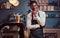 Portrait of successful African American owner small business smiling at camera while standing at the coffee shop.