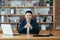 Portrait of a successful Asian businessman, man working in the office sitting at the table, looking at the camera and smiling,