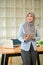 A portrait of a successful Asian Muslim businesswoman stands in her modern office