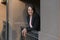 Portrait of successful business woman on the balcony. Smiling girl with bob haircut. Happy woman on break