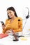 Portrait of successful customer supporter woman holding smartphone while working in call center