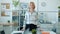 Portrait of successful mature business lady standing in office with happy smile looking at camera