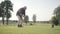 Portrait successful mature golfer swinging and hitting golf ball on beautiful course. Confident man golfing in beautiful