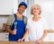 Portrait of successful plumber together with an elderly landlady in kitchen
