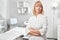 Portrait of successful professional doctor cosmetologist dermatologist woman in beauty salon smiling in white medical clothes