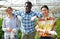 Portrait of successful satisfied farmers in the greenhouse on sunny day