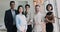 Portrait of successful team members posing for camera in office