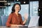 Portrait of successful tech support worker, hispanic woman with curly hair smiling and looking at camera, businesswoman